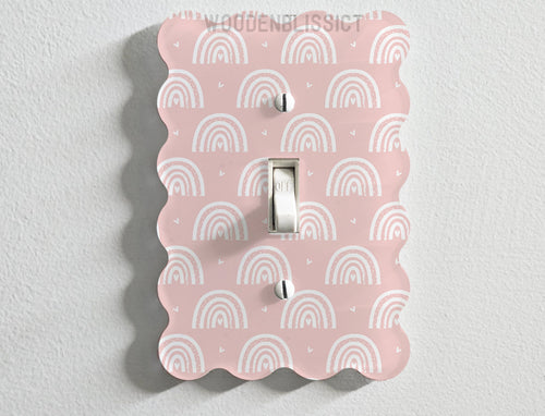 a light switch cover with a pink and white pattern